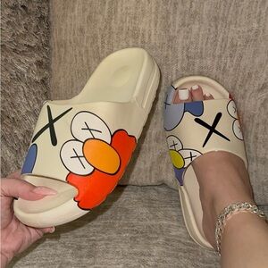 KAWS White Slip-on Slides sizes 8, 9, 10 left